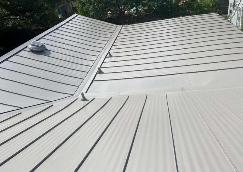Solar attic fan installed on a metal roof for Roof Ventilation in Boiling Spring Lakes
