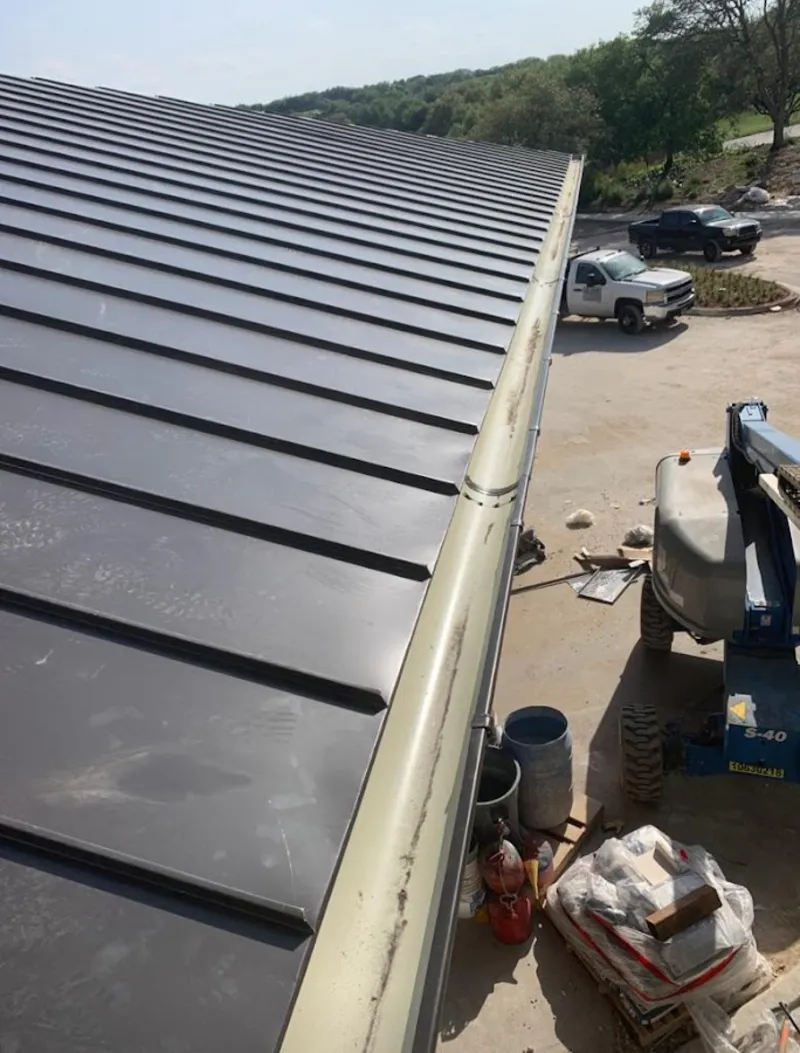 Standing seam panel and gutter detail on a metal roofing jobsite in Boiling Spring Lakes